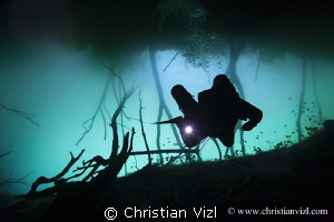 Cave diver at cenote Aktun Ha, Quintana Roo, Mexico by Christian Vizl 